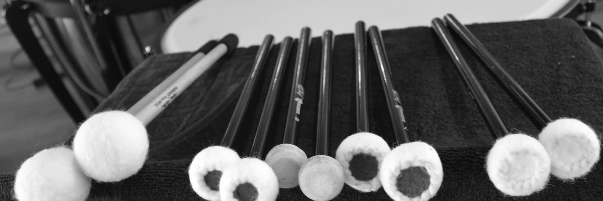 Image: Percussion mallets lying on stand in front of timpani (kettle drums)